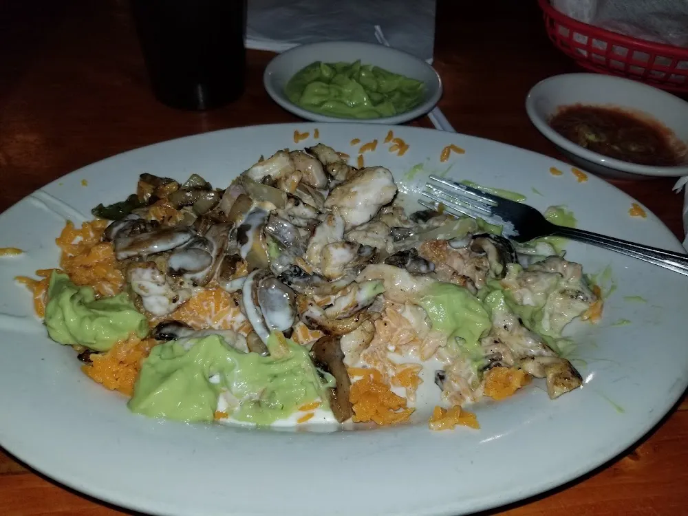 Chicken Shrimp Mushrooms and Onions over Rice with Cheese Poured over Top